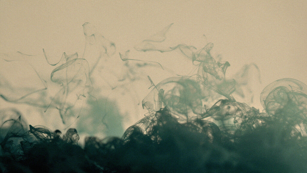 Fine soft matcha marks gathering and layering on a calm bone field and deepening into a denser deep-teal mass low in the frame, an abstract image of a load quietly accumulating over time.