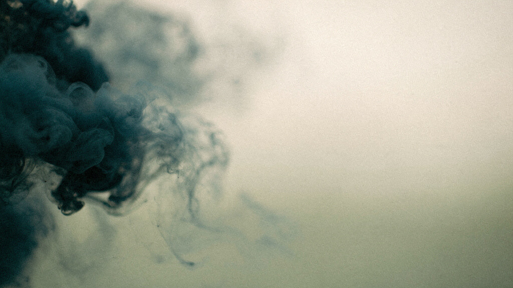 A dense deep-teal mass at one edge loosening and dissolving into open bone across the frame.