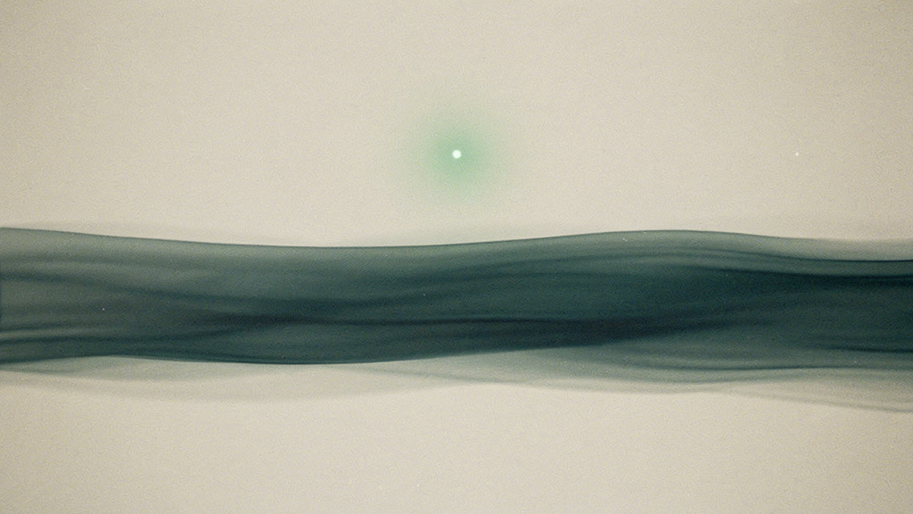 A single soft point of matcha light suspended against a long, layered band of teal and bone that carries steadily across the frame, suggesting one reading set against the longer line of a trend.