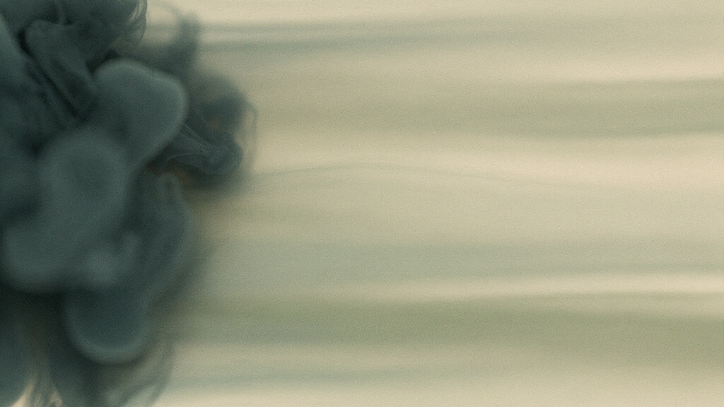 A wide warm bone field that shifts slowly from left to right. On the left a still, cool pool of deep teal holds tight and unmoving. Across the center it warms and begins to loosen into soft sage, and by the right edge it opens into light, flowing bands that seem to be in gentle motion. An abstract sense of a body moving from cold and static to warm and ready. Readiness is not a held position but a rising warmth; the body prepares by moving, not by staying still.